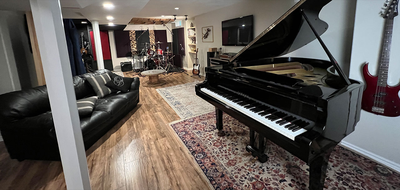 The Mix11 Studios live room, with grand piano, drum kit, and guitars